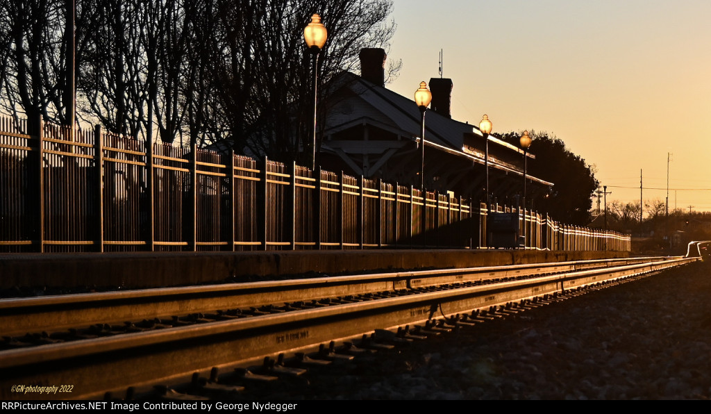 The station illuminated by the setting sun